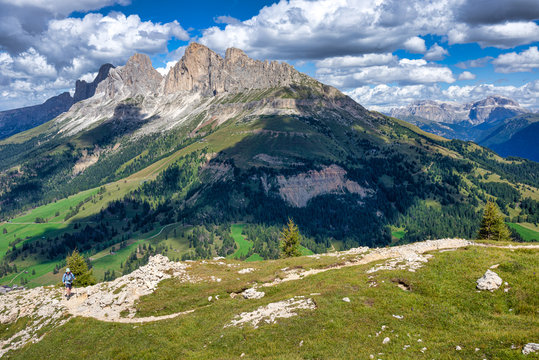 Woman hiking towards Pulpito di Cima Pope in the Latemar mountains, South Tyrol, Italy