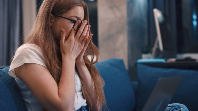 Feeling Tired And Stressed Frustrated Young Redhair Student Woman Keeping Eyes Closed At Home Young Businesswoman Is Tired Feels Stressed Out Close Up Slow Motion Freelancer Internet Job Study Online