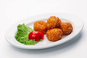 cheese balls on a white plate and a white background