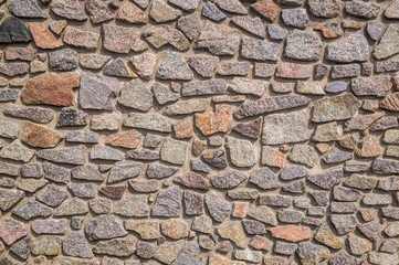 Vintage texture of stonework old masonry. Granite Cobblestone Wall