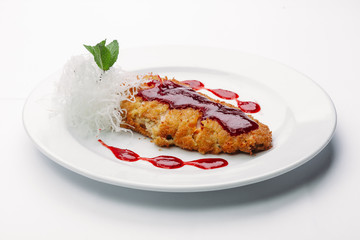 chop on a plate with red sauce