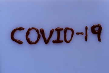 Tomato sauce with an inscription COVID-19 on white background