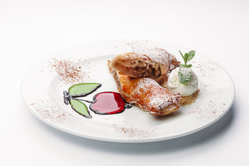dessert of pancakes, ice cream, and fruit on a white background