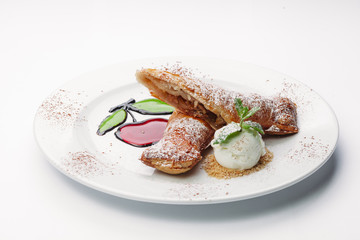 dessert of pancakes, ice cream, and fruit on a white background