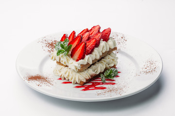 Delicious slice of Torata on a white background with strawberries