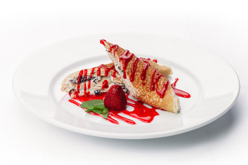 dessert of pancakes, ice cream, and fruit on a white background