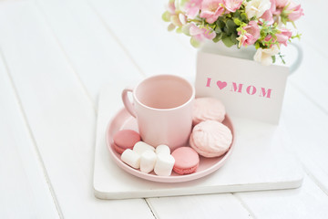 Mother's Day Greeting Card. Romantic breakfast. Happy mothers day frame background. Tea set with flowers and sweet. Spring card template. Happy Birthday or Valentine. Women's Day. Copy space.