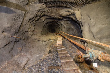 Underground gold quartz mine incline tunnel with stairs ladder