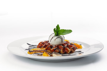 dessert of pancakes, ice cream, and fruit on a white background