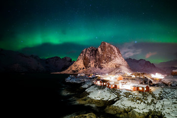 Fototapeta na wymiar The Northern Lights over Hamnoy Island which is the one of the most popular place in Lofoten Island, Norway