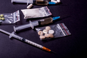 Hard drugs on dark table. concept of crime and addiction. Drug heroin, syringes
