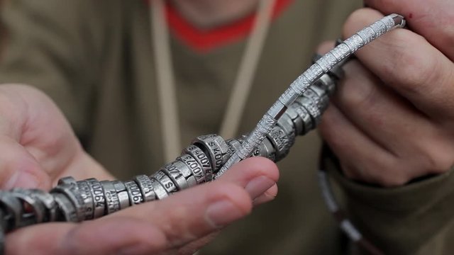 Man hand showing bird ringing for scientific purpose. Ornithologist / biologist holding bird ring for research study. Science, biology, nature, conservation, fauna, research and ornithology.