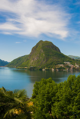 View of Lake Lugano and Mount San Salvatore on a sunny summer day. Alpine mountain scenery in the city of Lugano, Switzerland. 