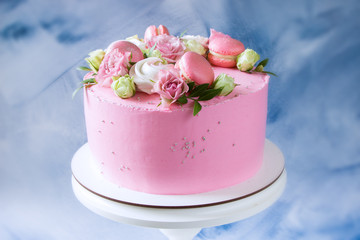 Modern pink cake with fresh roses and macaroons. Concept for Wedding , St. Valentine's Day, Mother's Day, Birthday Cake.