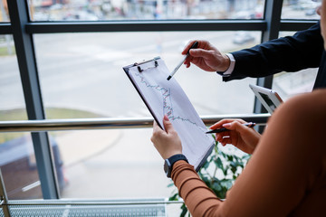 Girl manager in her own office tells a successful new business plan for economic development to her...