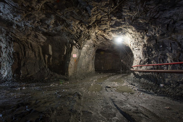 Fototapeta na wymiar Underground gold quartz mine shaft tunnel drift with light