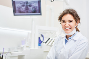 Smiling woman as a dentist or dental assistant