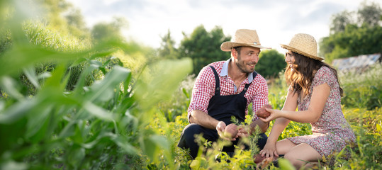 Young couple working in their organic garden