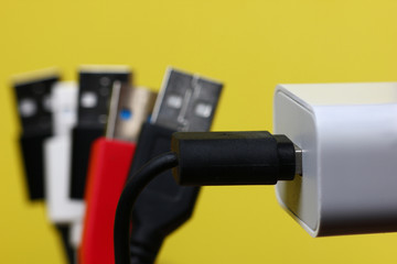 colored usb charging cables on a yellow background