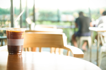Iced americano coffee mix with orange juice and slice orange