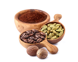 Coffee beans and ground coffee with spices. Coffe beans with nutmegs and cardamom.