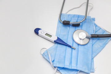 Protection Mask, Thermometer And Stethoscope for protection against viruses on a white background