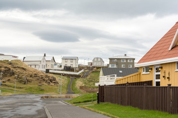 Fototapeta na wymiar Olavsvik, Iceland : 2017 MAY 14 : Cloudy day in the street ofon Olavsvik, a typical Icelandic town in the Snaefellsnes peninsula