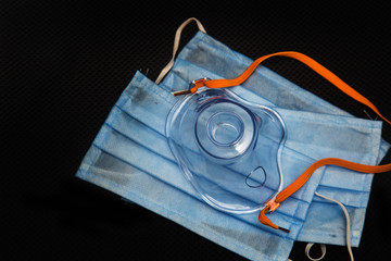 Medical and oxygen masks on black background
