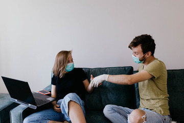 loving couple in medical masks on quarantine communicate about intimate relationships. self-isolation and love.