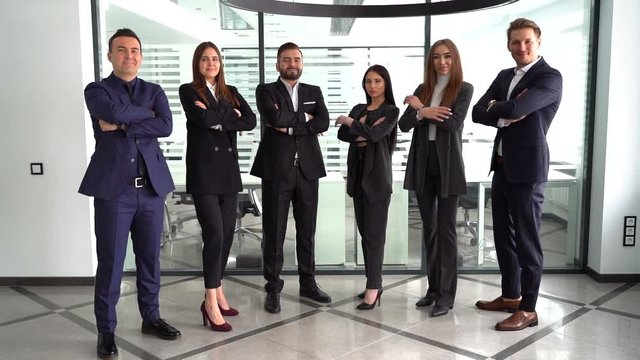 business colleagues headed with boss, posing to camera over in office,slow motion