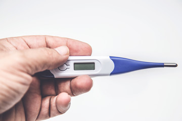 Hand holding thermometer.