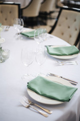 wedding table setting with flowers and green 
napkins