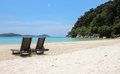 wooden sun loungers on the beach