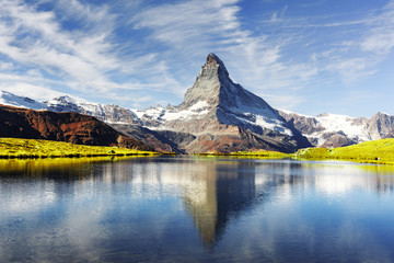 Picturesque view of Matterhorn Cervino peak and Stellisee lake in Swiss Alps. Day photo with blue...