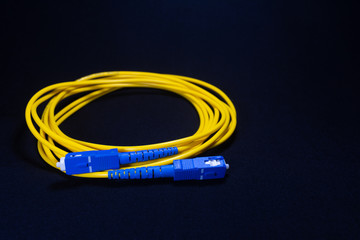 SC SC CONNECTOR YELLOW OFC PATCH CORD SQUARE CONNECTOR IN BLACK BACKGROUND TELE COMMUNICATION