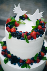  wedding cake with berries and birds