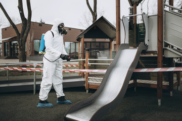 Cleaning and Disinfection on the playground in the sity complex amid the coronavirus epidemic Teams...