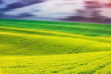 Abstract rural landscape with agricultural fields on spring hills. South Moravia region, Czech Republic