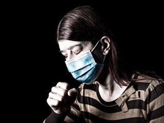 Woman with surgical mask sneezing or coughing. Pandemic or epidemic and scary, fear or danger concept. Protection for biohazard like COVID-19 aka Coronavirus. Black Background