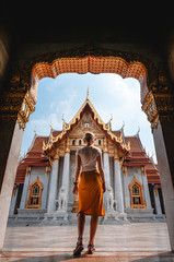 Fototapeta premium Beautiful woman observing temple on holiday in Bangkok, Thailand