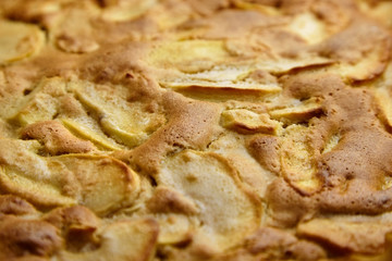 Apple pie, dessert from stewed fruits, closeup, texture, background. Charlotte, homemade baking