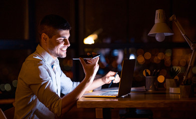 Young Entrepreneur Using Voice Assistant Working On Laptop In Office