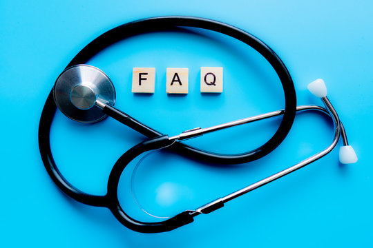 Wooden Block Form The Word FAQ With Stethoscope. Medical Concept.