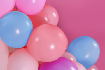 Beautiful colorful balloons on pink background, closeup. Party decor
