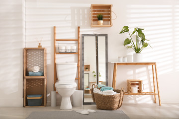 Interior of stylish bathroom with toilet bowl and decor elements