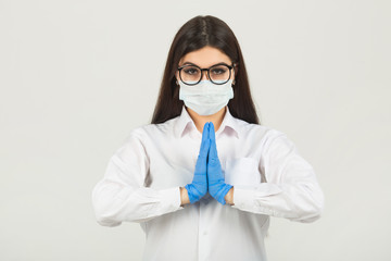 young woman in medical face mask on white background with hand gesture