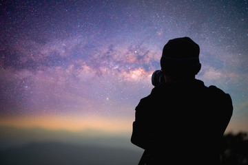 Photographer or Traveller using a professional DSLR camera take photo beautiful landscape of Milky...