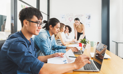 Asian business people working with laptop, searching data for business startup plan and strategy