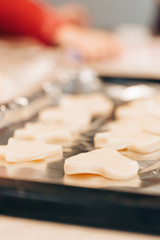 Child cuts out cookies from dough