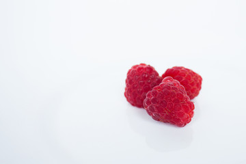 raspberries in shape of heart isolated on white